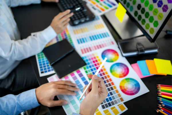 team looking at web design color scheme options